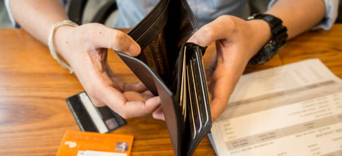 Hands holding open a wallet