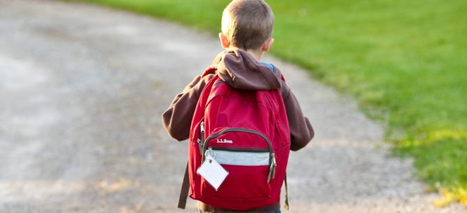 Boy walking alone down the street